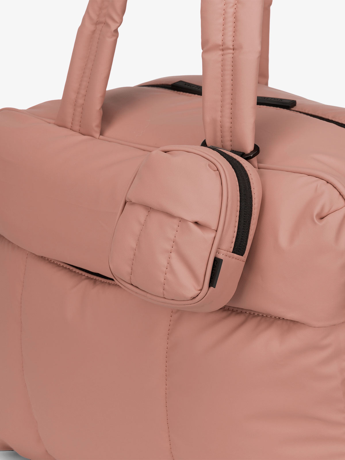 CALPAK Luka mini backpack keychain attached to duffel with carabiner clip in pink peony; AMB2201-PEONY