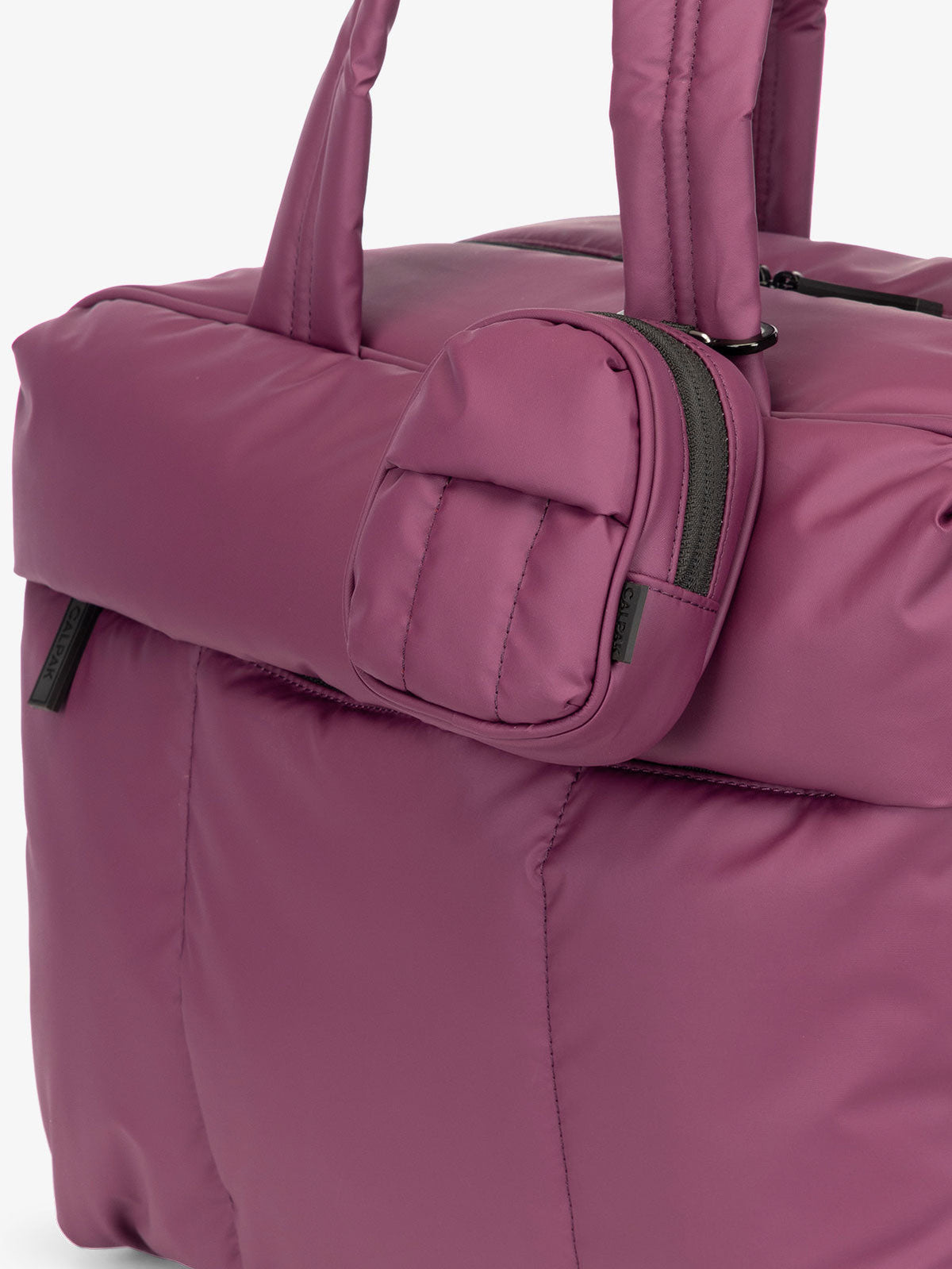CALPAK Luka mini backpack keychain attached to duffel with carabiner clip in purple plum; AMB2201-PLUM
