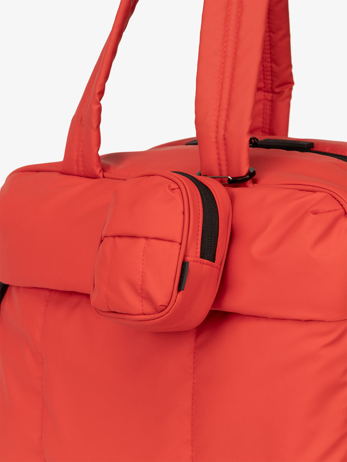 CALPAK Luka mini backpack keychain attached to duffel with carabiner clip in red rouge; AMB2201-ROUGE