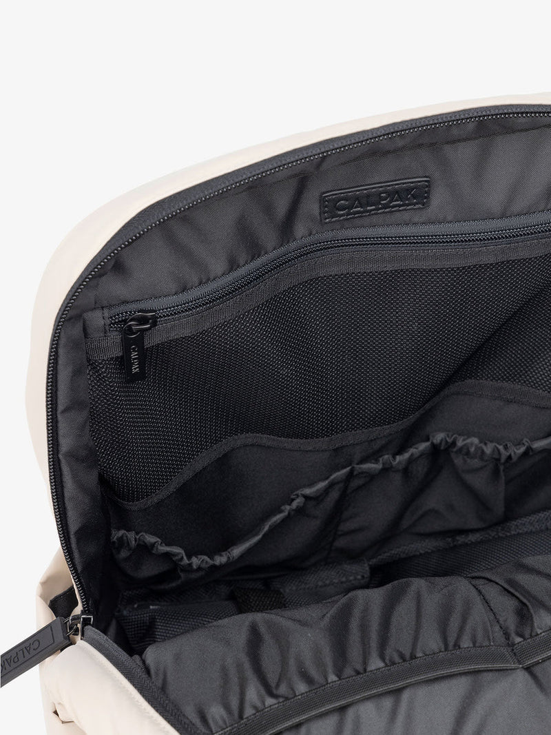 Close-up of the Luka 15 backpack's interior, highlighting its mesh zippered compartment and various organizational pockets.