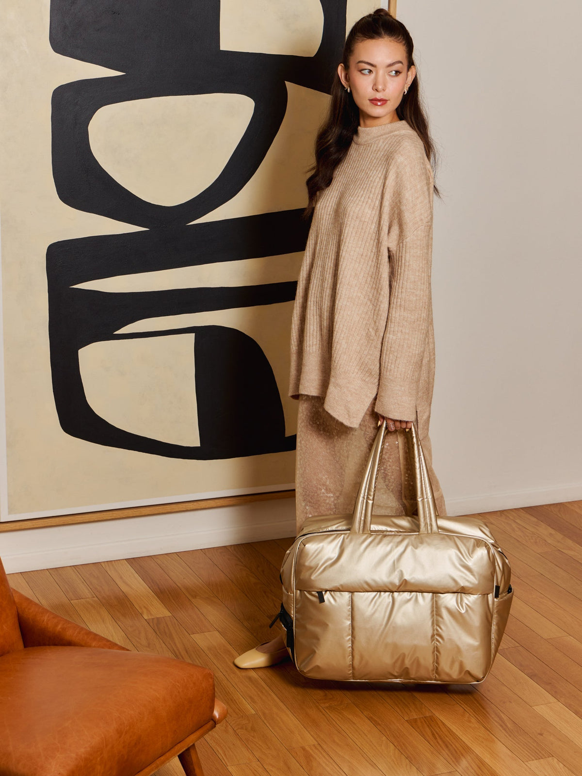 Model holding metallic gold Luka Large Duffel; DLL2201-GOLD