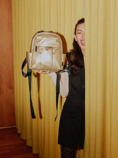 CALPAK Luka Mini Backpack with soft puffy exterior and front zippered pocket in metallic gold; BPM2201-GOLD