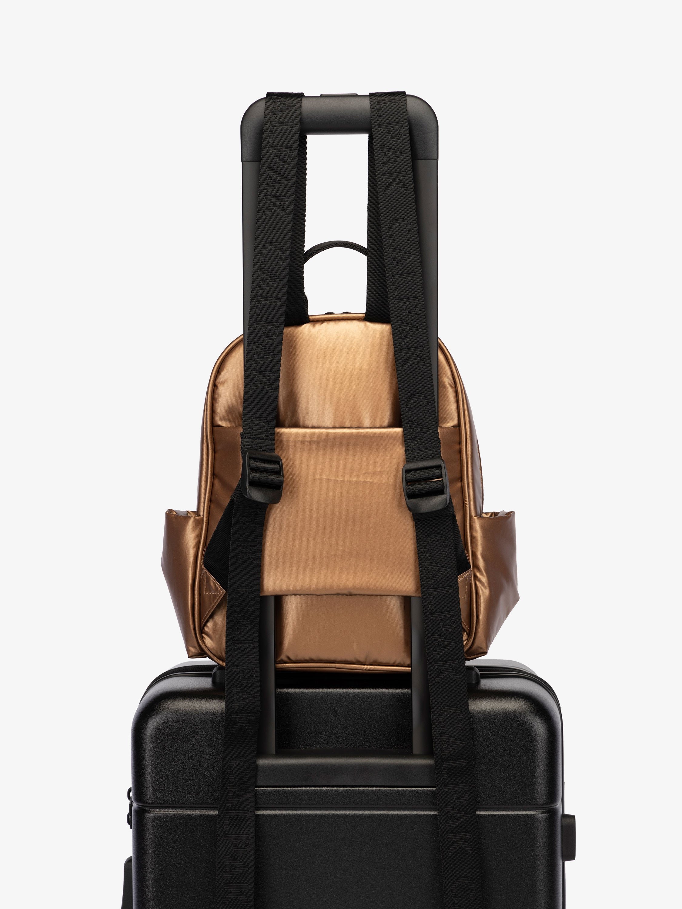 CALPAK Luka small travel Backpack with luggage sleeve and adjustable straps in shiny copper