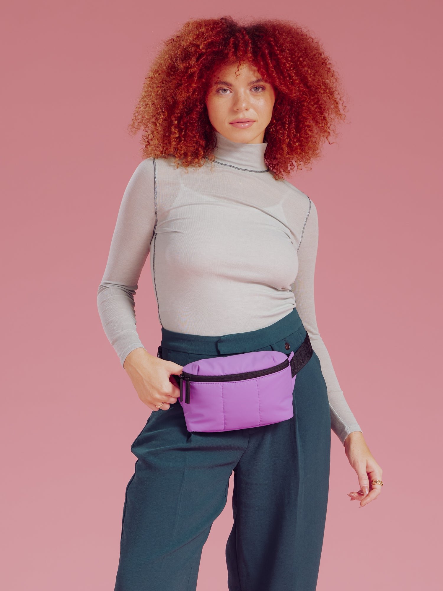 Model wearing CALPAK Luka Mini Belt Bag around waist in lavender lilac