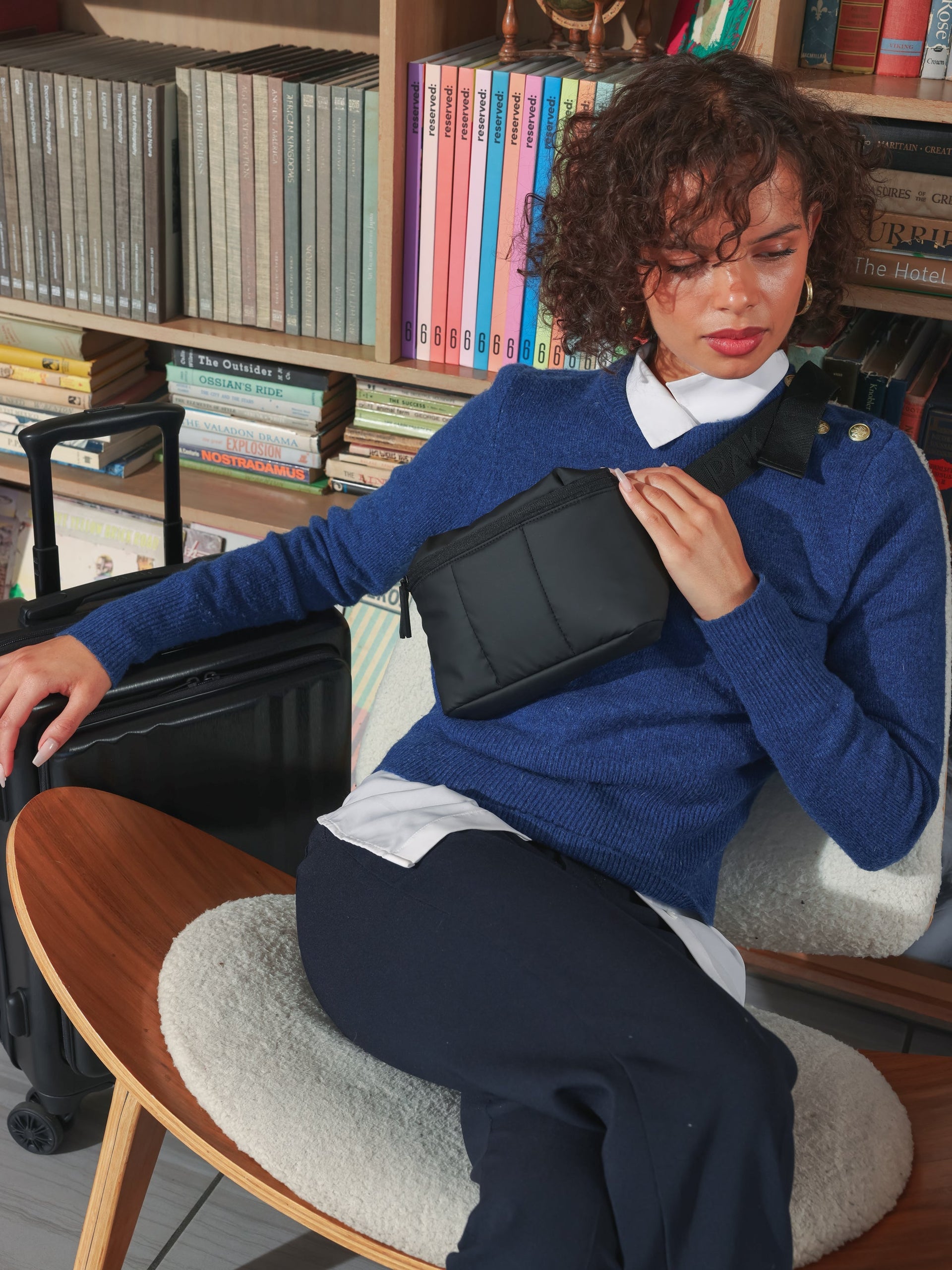 Model wearing CALPAK Luka mini crossbody fanny pack in black; BBM2201-MATTE-BLACK