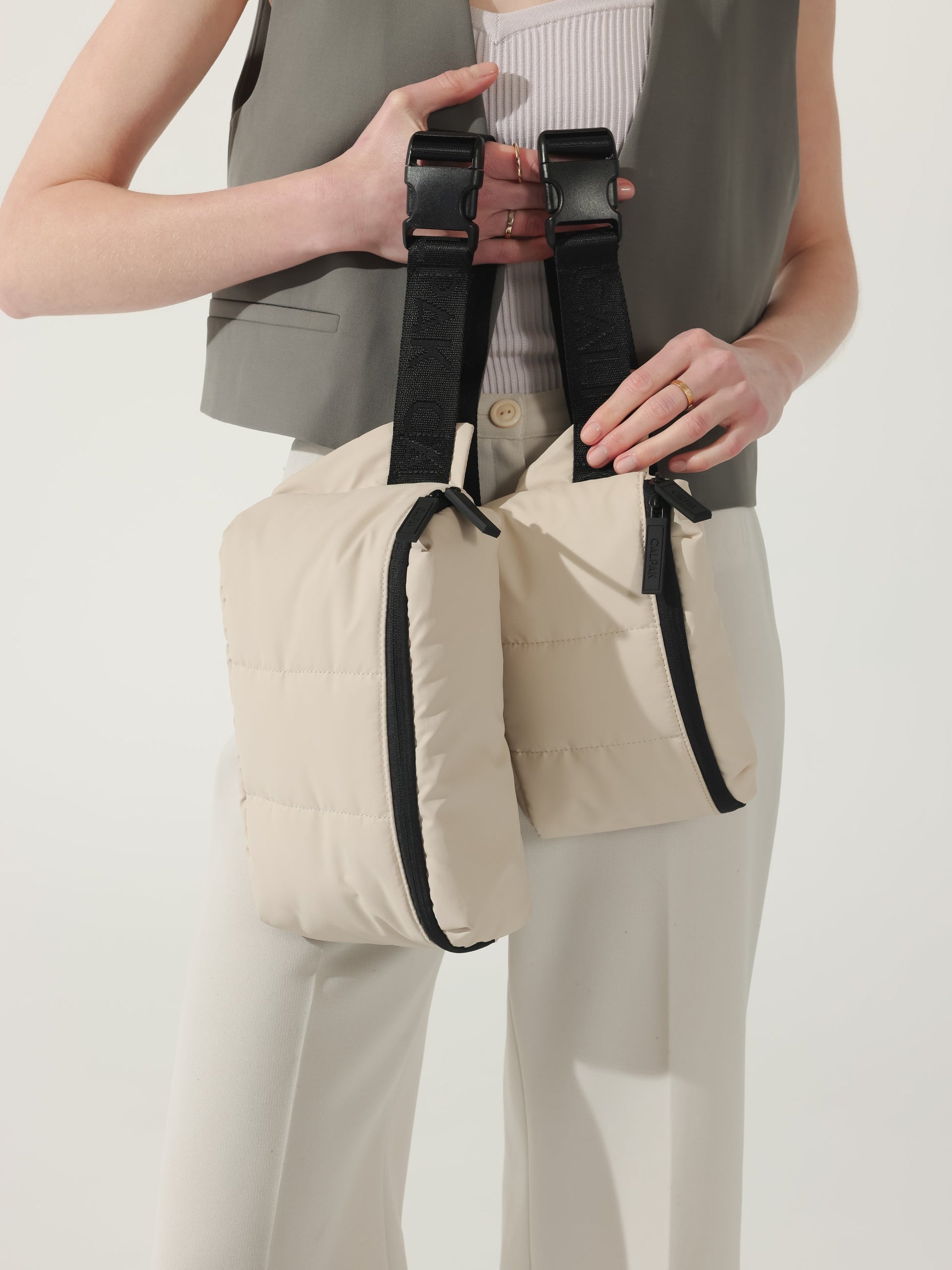 CALPAK Luka small Belt Bag pictured with Luka Belt bag with puffy exterior in ivory; BBM2201-OATMEAL