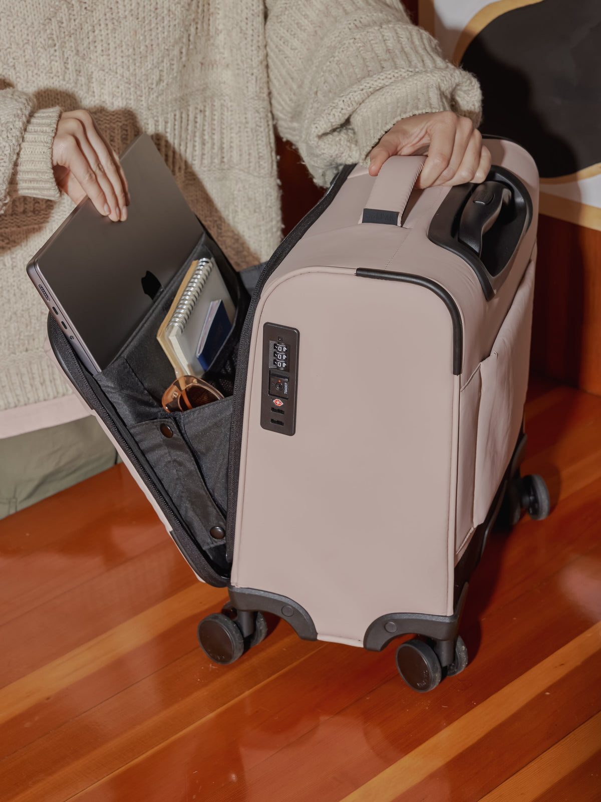 Model packing CALPAK carry-on Luka mini soft luggage with laptop compartment, TSA lock and spinner wheels in rose quartz; LSM1014-ROSE-QUARTZ