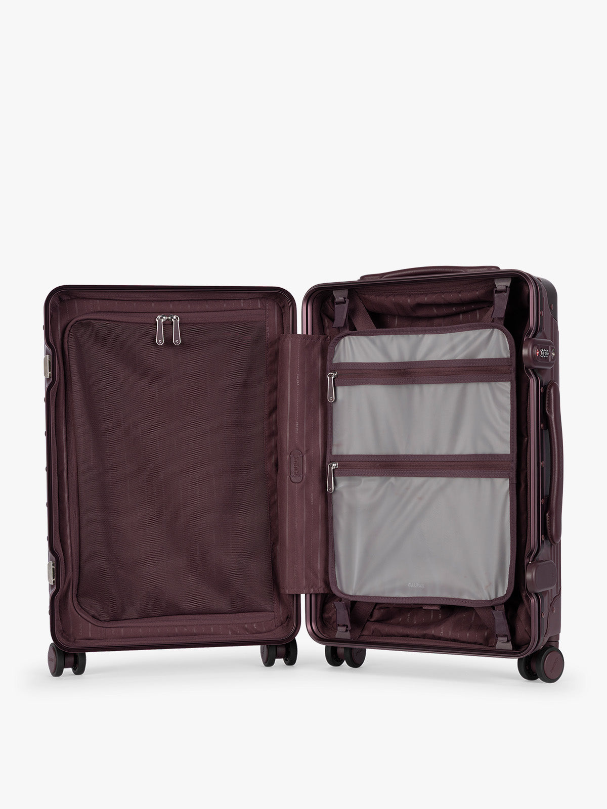 Opened showing grey attachment with zipper of CALPAK Vault deep red Dark Cherry hard-shell spinner Carry On Luggage with a telescoping handle extended, featuring a deep red leatherette side handle and trim, set against a plain light gray background; LVT1020-DARK-CHERRY
