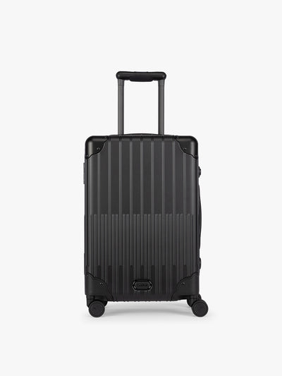 CALPAK Vault black Onyx hard-shell spinner Carry On Luggage with a telescoping handle extended, featuring a Black leatherette side handle and trim, set against a plain light gray background; LVT1020-ONYX view 1