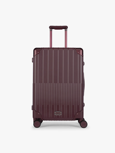 CALPAK Vault Luggage in Medium Dark Cherry deep red hard-shell spinner suitcase with a ribbed vertical design, shown from the front against a clean white background; LVT1024-DARK-CHERRY view 1