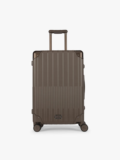 CALPAK Vault luggage brown Mushroom hard-shell spinner suitcase with a ribbed vertical design, shown from the front against a clean white background; LVT1024-MUSHROOM view 1