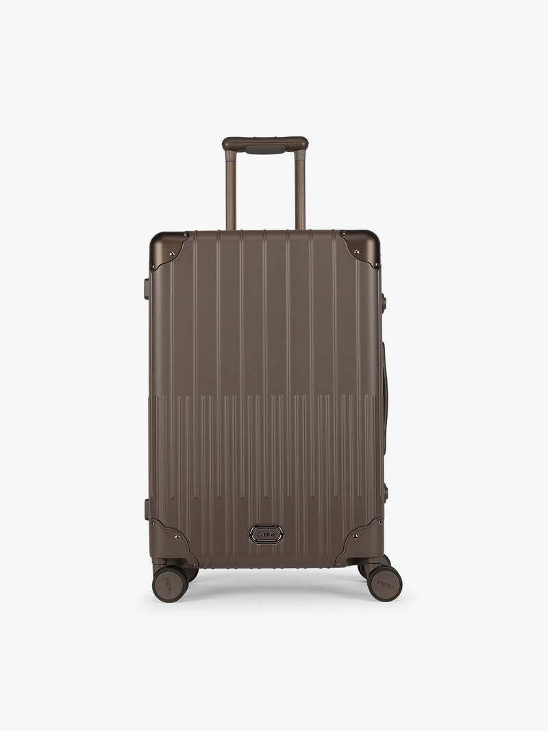 CALPAK Vault luggage brown Mushroom hard-shell spinner suitcase with a ribbed vertical design, shown from the front against a clean white background
