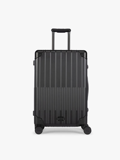 CALPAK Vault Luggage Onyx black hard-shell spinner suitcase with a ribbed vertical design, shown from the front against a clean white background; LVT1024-ONYX view 1