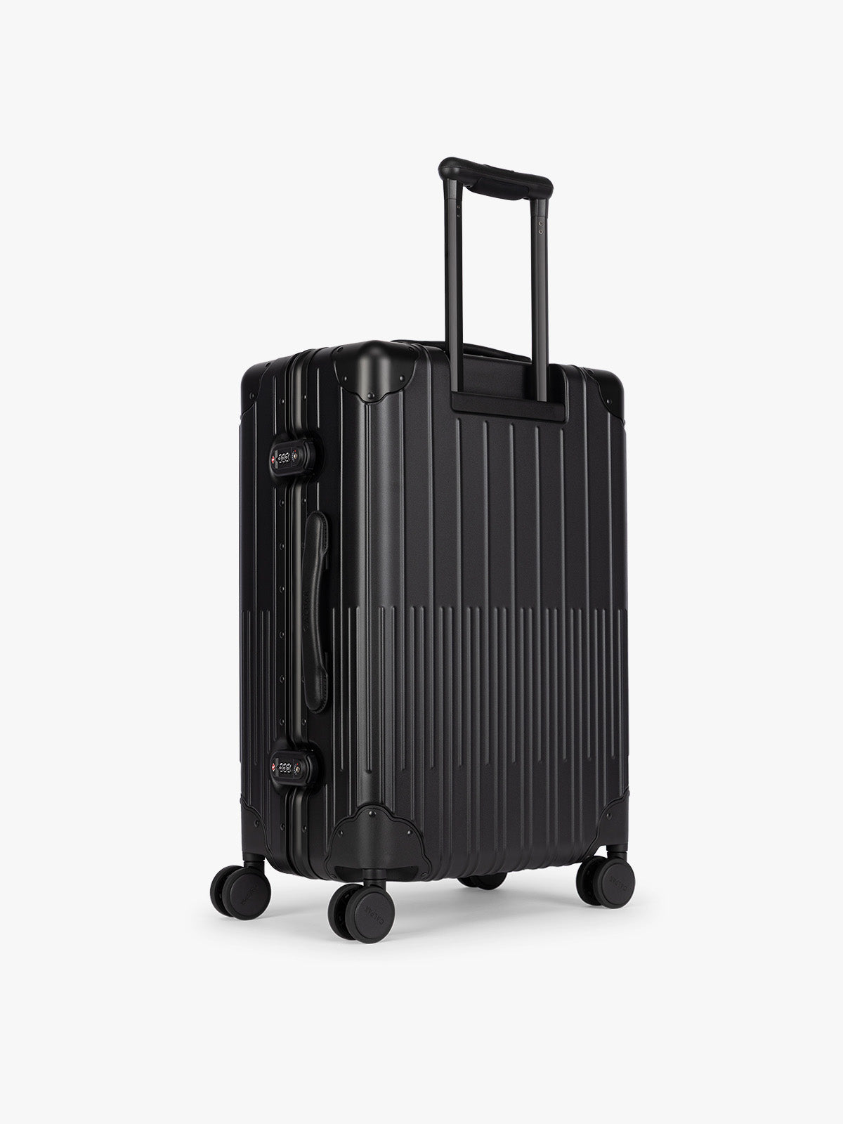 Backside of CALPAK Vault Luggage Onyx black hard-shell spinner suitcase with a ribbed vertical design, shown from the front against a clean white background; LVT1024-ONYX