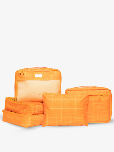 CALPAK 5 piece set packing cubes for travel with labels and top handles in orange grid; PC1601-ORANGE-GRID view 1