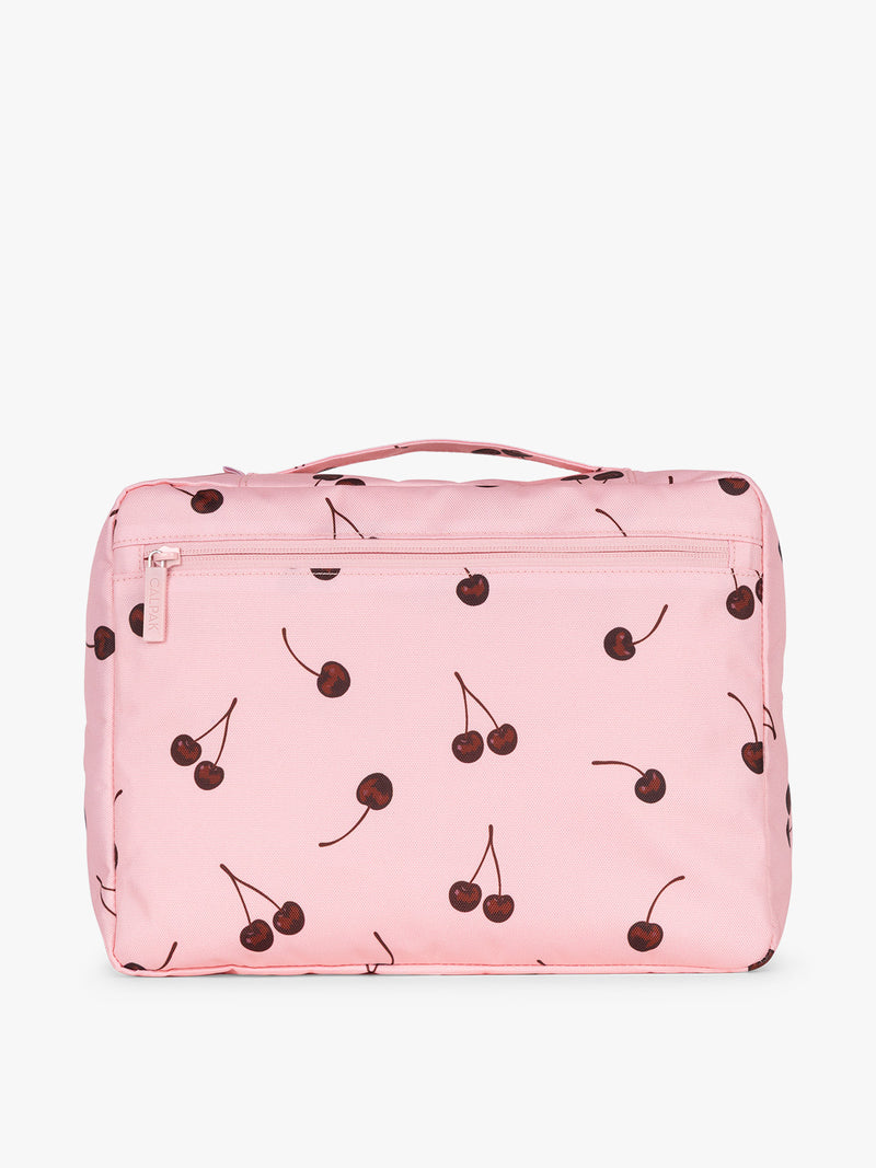 Back view of one CALPAK Packing Cubes 5pc Set in pink with cherry print in Blossom Cherry on a white background