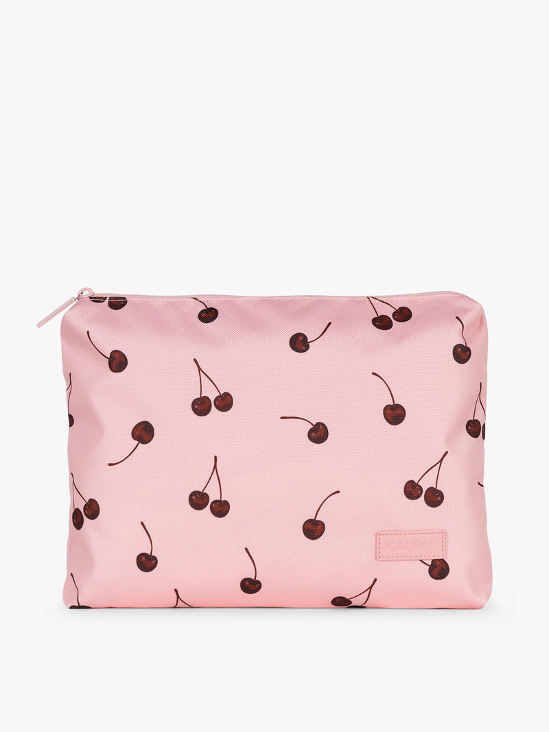 Zippered bag that is part of CALPAK Packing Cubes 5pc Set in pink with cherry print in Blossom Cherry on a white background