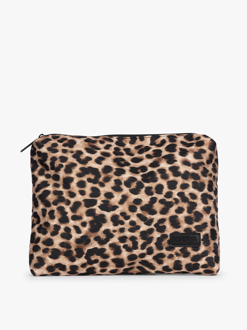 Tan and black animal print Snow Leopard CALPAK 5-piece travel packing cubes set with close up of envelope cube with top zipper, displayed on a clean white background