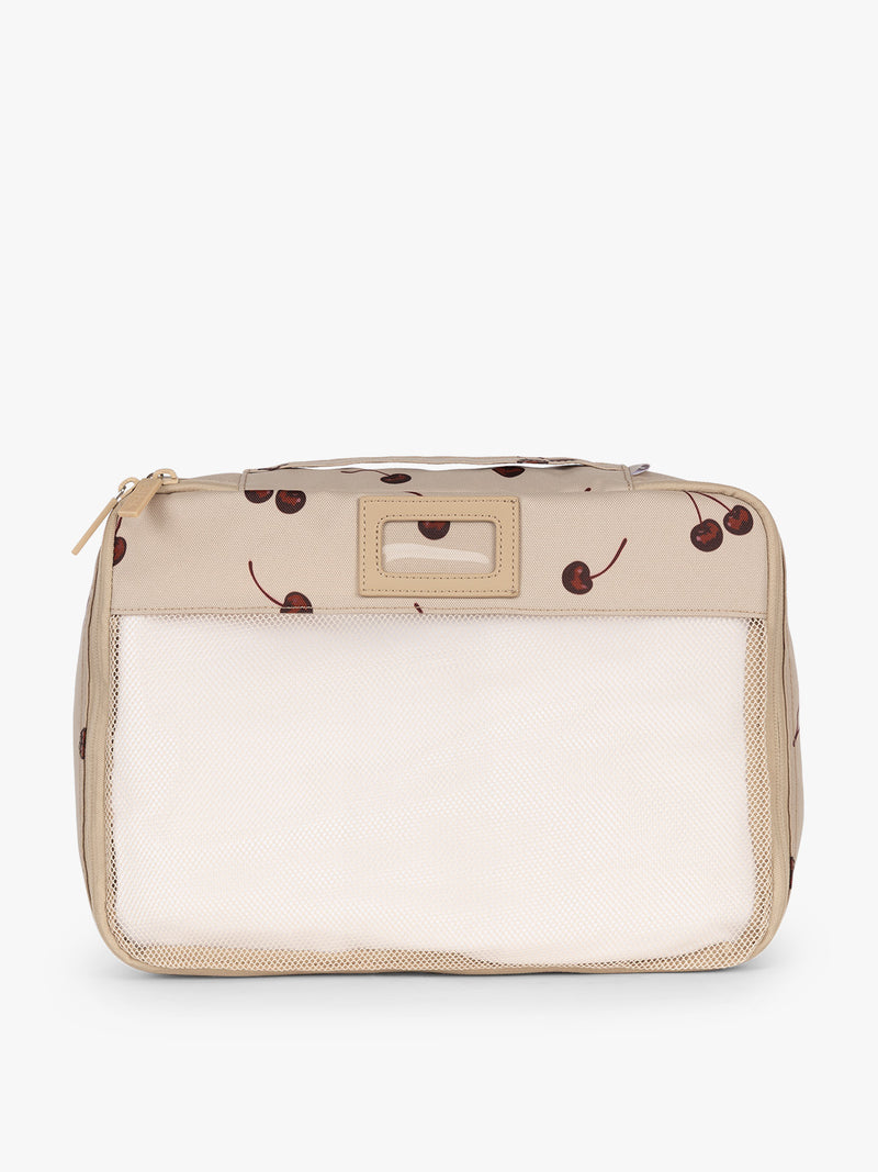 Front view of CALPAK Packing Cubes 5pc Set in beige with cherry print in Oatmeal Cherry on a white background