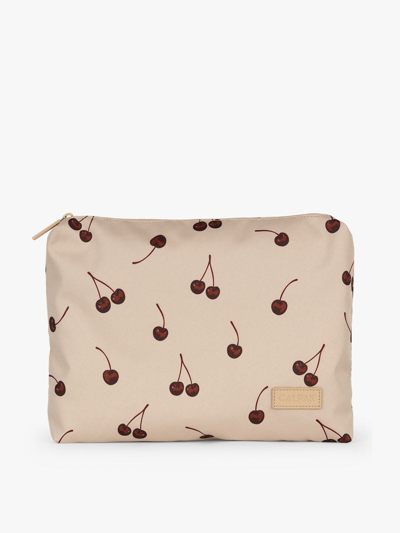 Zippered bag of CALPAK Packing Cubes 5pc Set in beige with cherry print in Oatmeal Cherry on a white background