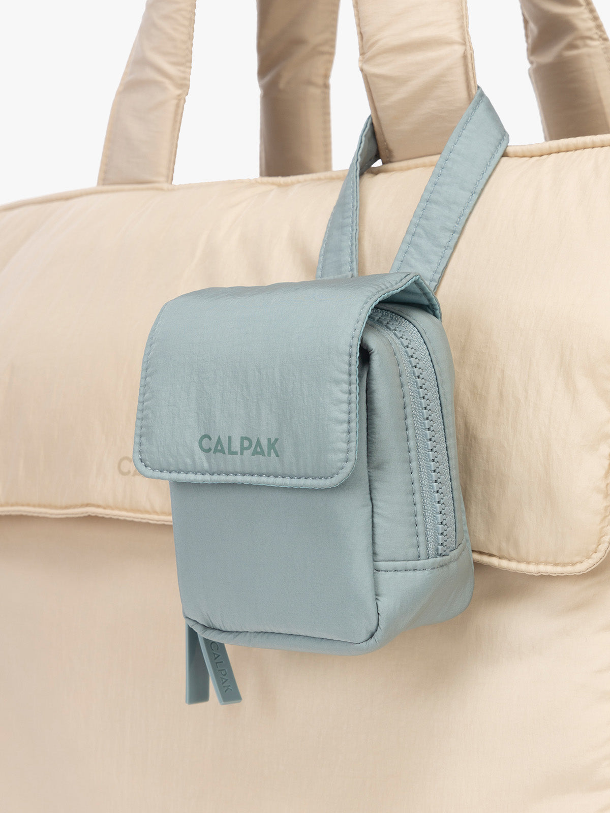 CALPAK Baby Collection Pacifier Pouch in light blue Bluebell clipped onto white bag; PCB2501-BLUEBELL