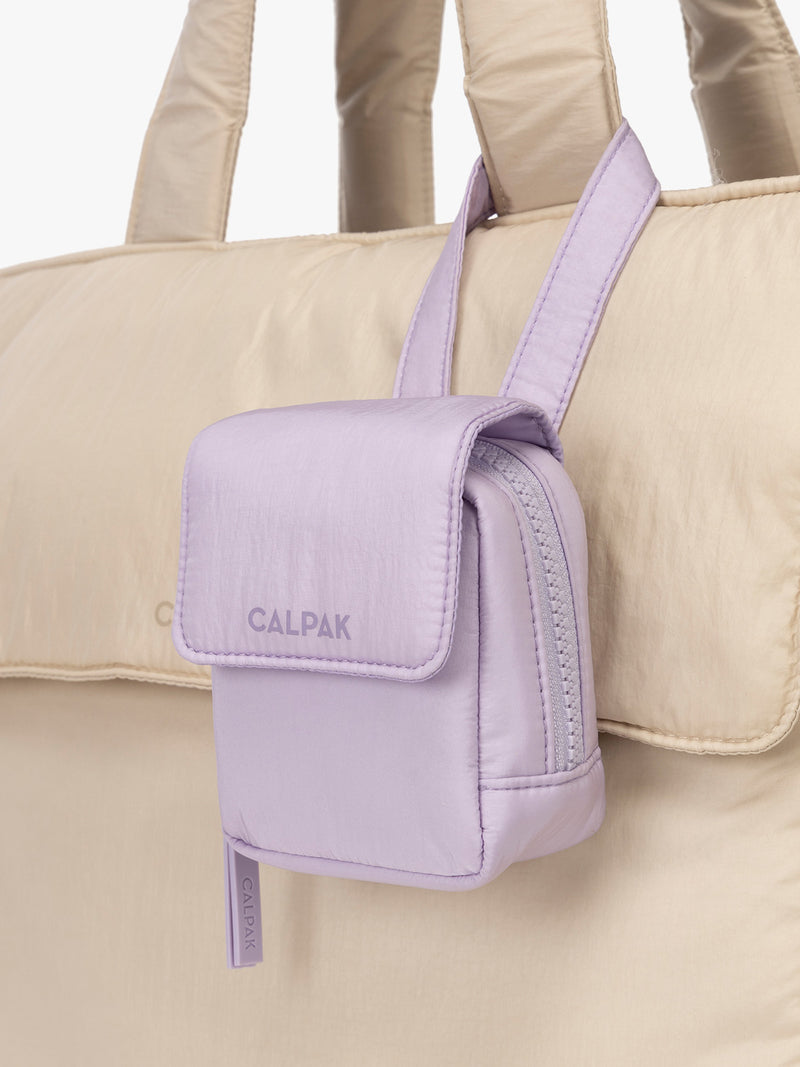 CALPAK Baby Collection Pacifier Pouch in lavender purple Orchid clipped onto white bag