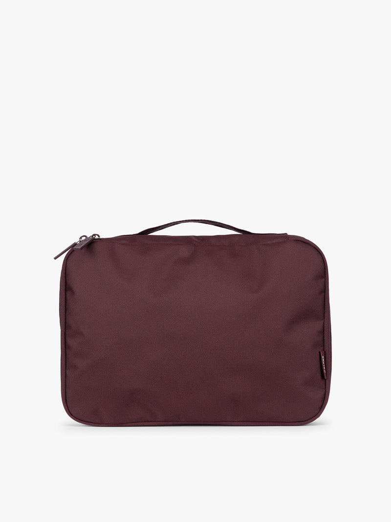 Closeup of a single Medium Compression Packing Cube in burgundy Dark Cherry CALPAK Medium Compression Packing Cubes with zippers shown on a clean white background