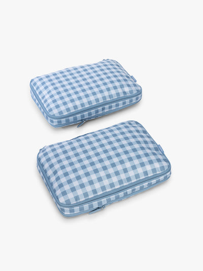 CALPAK Medium Compression Packing Cubes (Set of 2) compressed in white and blue gingham print in French Blue Gingham; PCC2201-FRENCH-BLUE-GINGHAM view 1