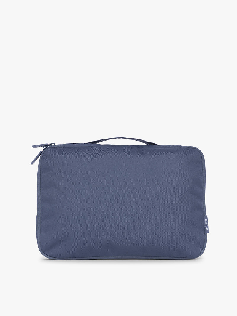 Front view of CALPAK Medium Compression Packing Cubes (Set of 2) compressed in dark blue Indigo