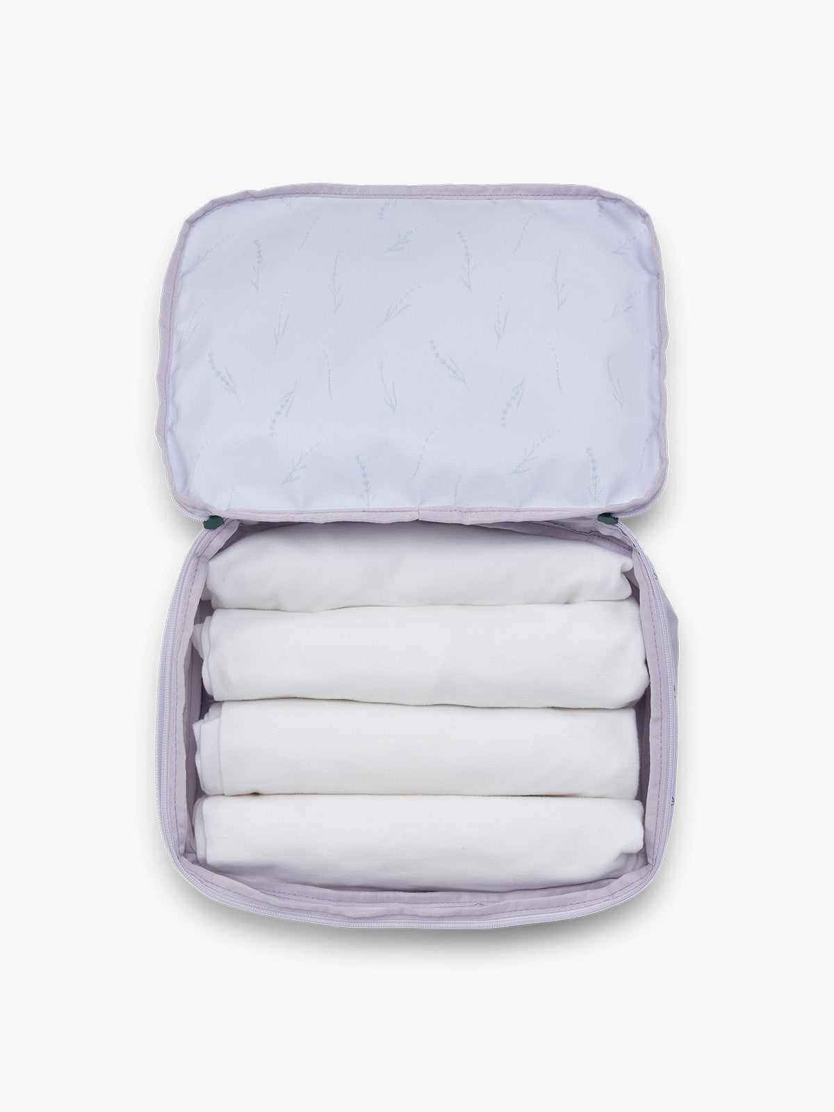 Towels rolled up in the CALPAK Medium Compression Packing Cubes (Set of 2) in light purple with lavender print in Lavender Bloom; PCC2201-LAVENDER-BLOOM