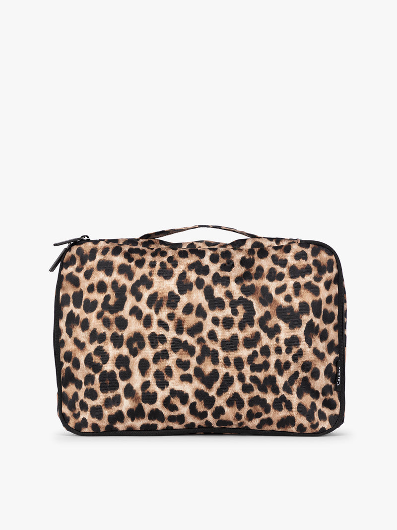 Closeup of one tan and black animal print Leopard CALPAK Medium Compression Packing Cubes with zippers shown on a clean white background
