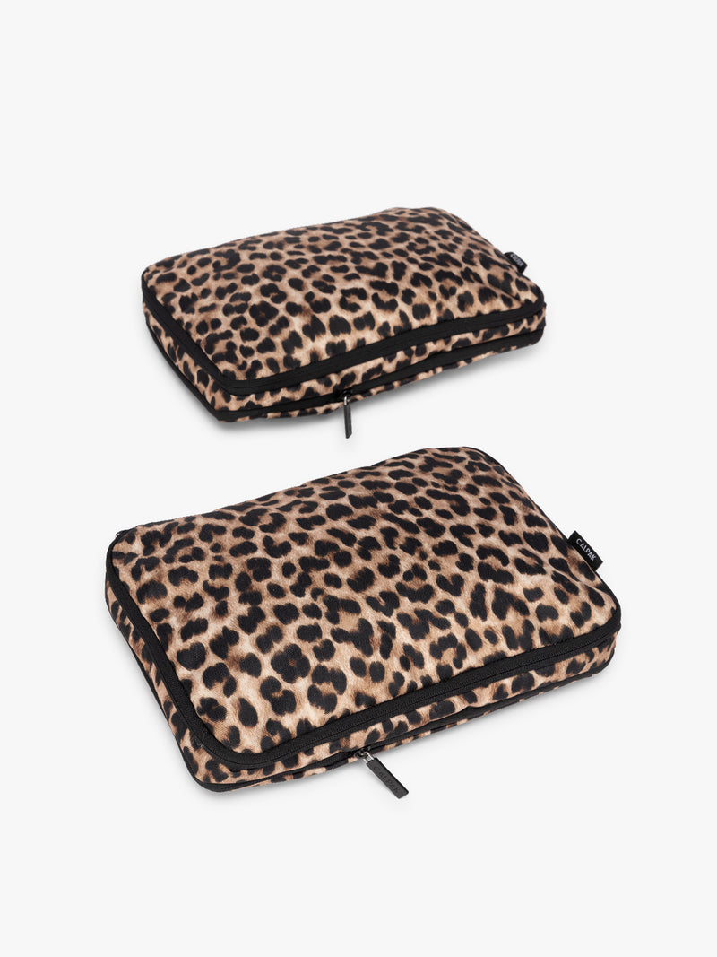 Two tan and black animal print Leopard CALPAK Medium Compression Packing Cubes with zippers shown on a clean white background
