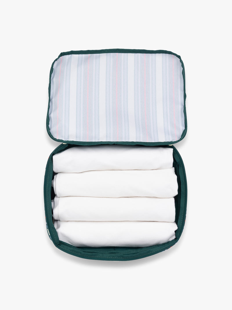 Opened CALPAK Medium Compression Packing Cubes in multicolor stripe