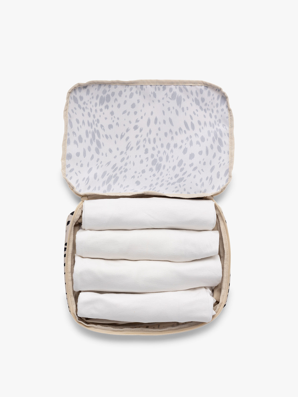 Opened view with clothing inside the white and black animal print Snow Leopard CALPAK Medium Compression Packing Cubes with zippers shown on a clean white background; PCC2201-SNOW-LEOPARD