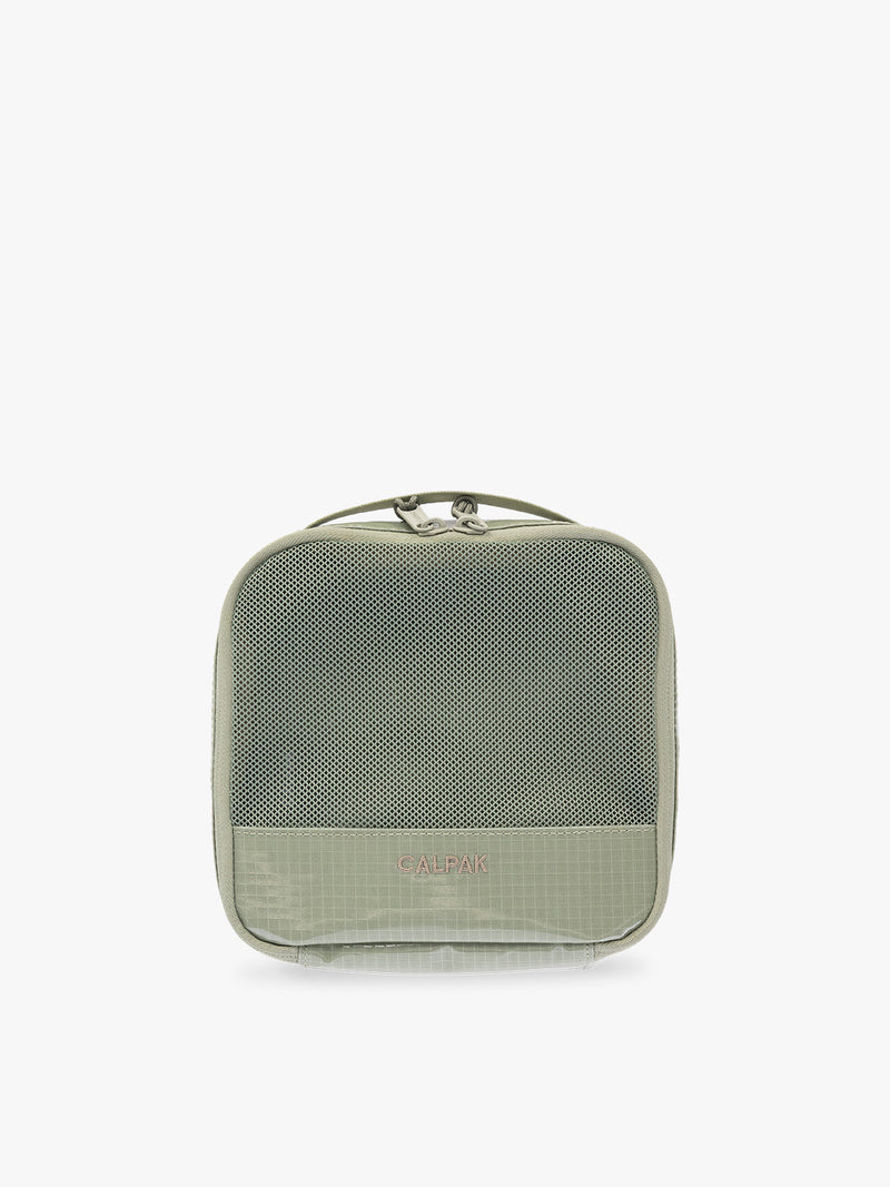 Small size packing cube of the CALPAK Terra 5-Piece Packing Cube Set in olive green Juniper with two small cubes, two medium cubes, and one large mesh cube with zippers and mesh