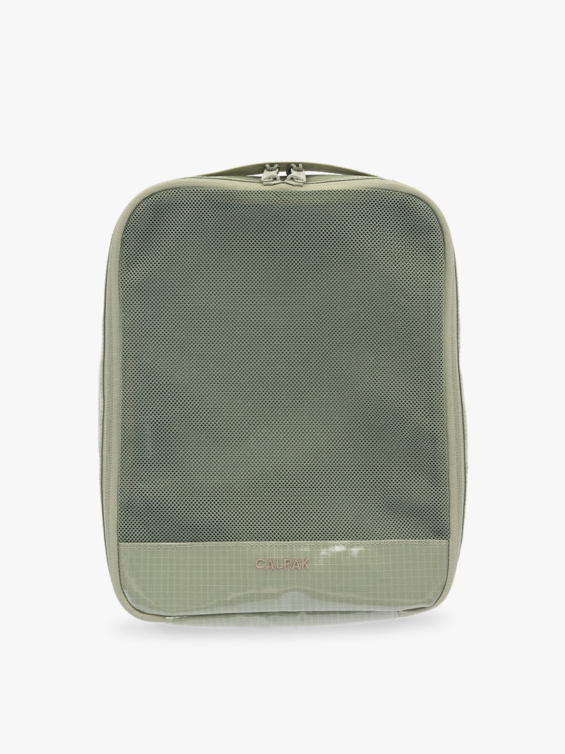 Medium size packing cube of the CALPAK Terra 5-Piece Packing Cube Set in olive green Juniper with two small cubes, two medium cubes, and one large mesh cube with zippers and mesh