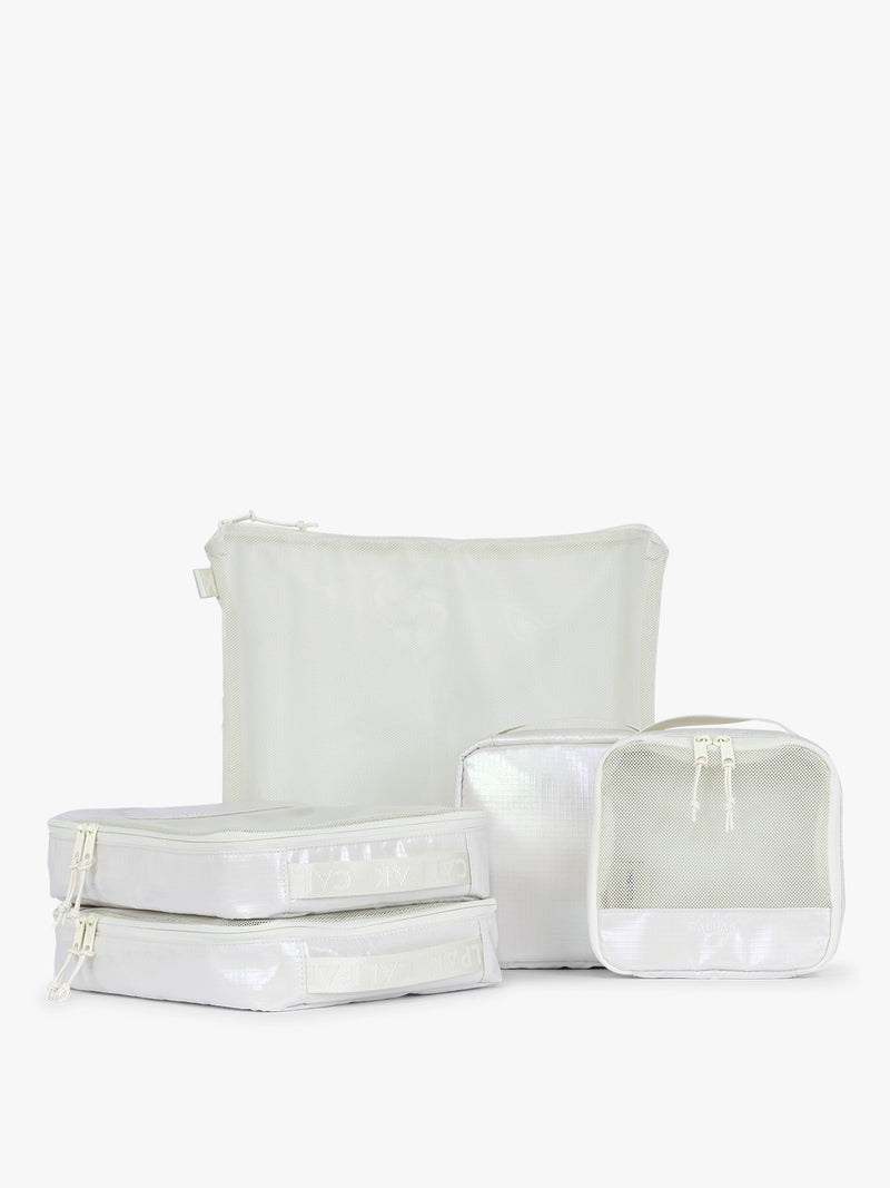 CALPAK Terra 5-Piece Packing Cube Set in shiny white iridescent Moonbeam with two small cubes, two medium cubes, and one large mesh cube with zippers and mesh