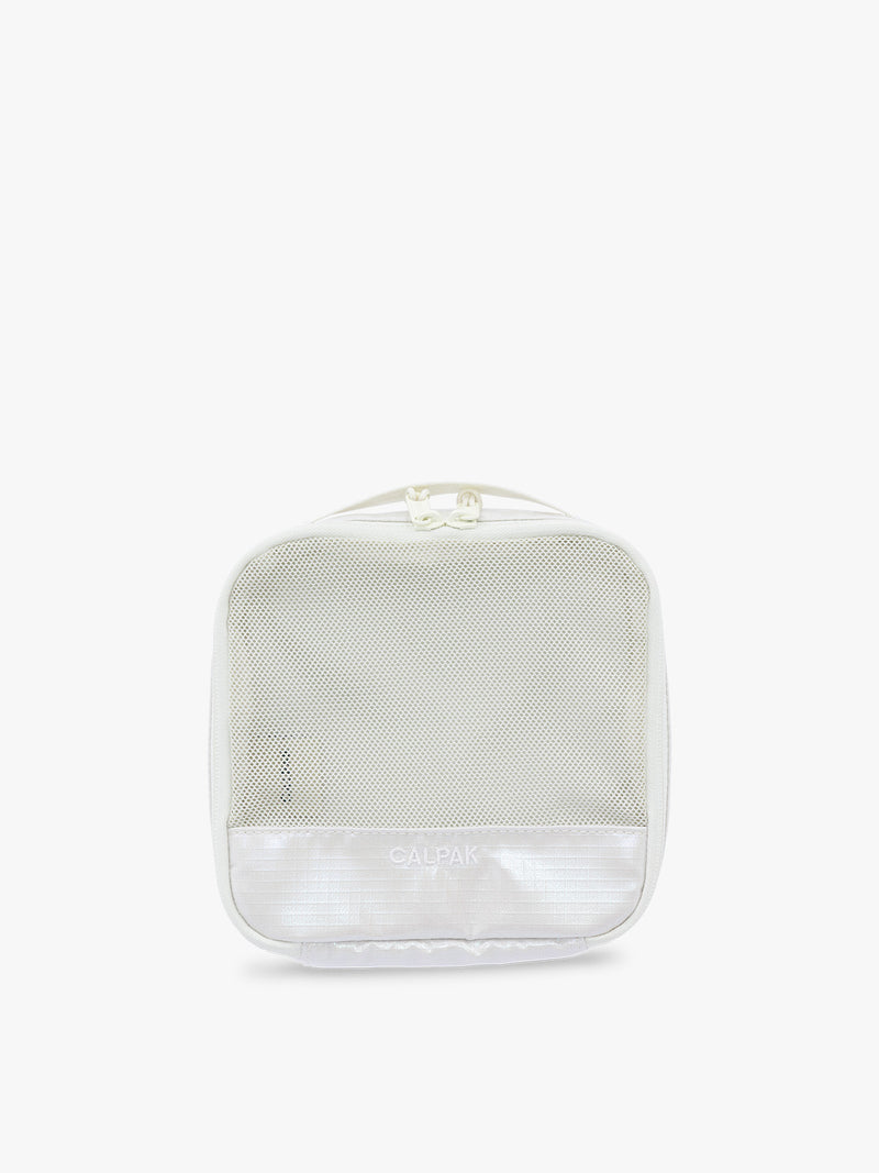 Small size packing cube of CALPAK Terra 5-Piece Packing Cube Set in shiny white iridescent Moonbeam with two small cubes, two medium cubes, and one large mesh cube with zippers and mesh