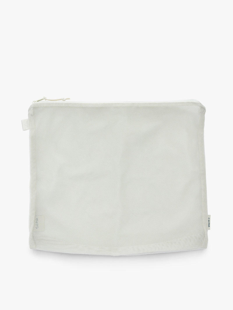 Large size packing cube of the CALPAK Terra 5-Piece Packing Cube Set in shiny white iridescent Moonbeam with two small cubes, two medium cubes, and one large mesh cube with zippers and mesh