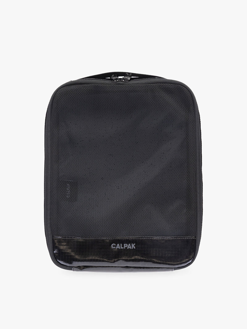 Medium size packing cube of the CALPAK Terra 5-Piece Packing Cube Set in black Obsidian with two small cubes, two medium cubes, and one large mesh cube with zippers and mesh