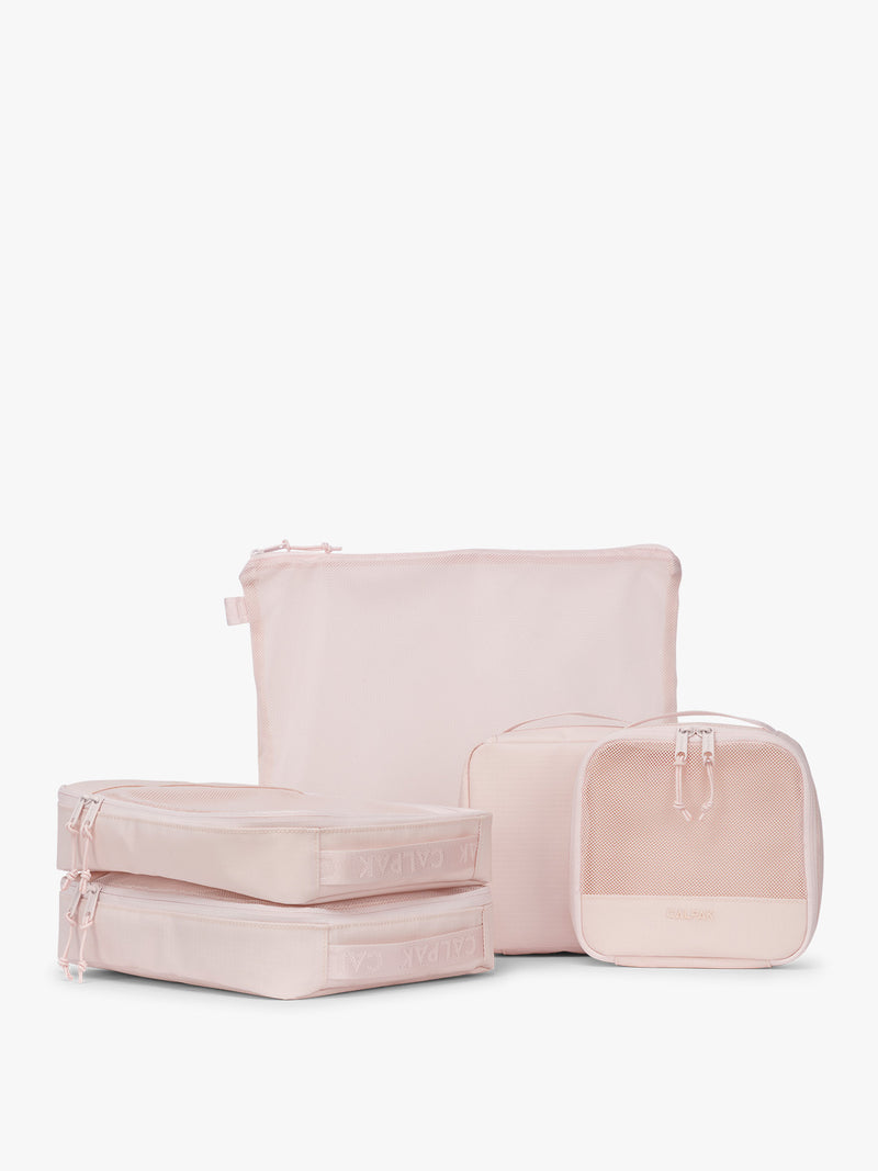 CALPAK Terra 5-Piece Packing Cube Set in pink Shell Pink with two small cubes, two medium cubes, and one large mesh cube with zippers and mesh
