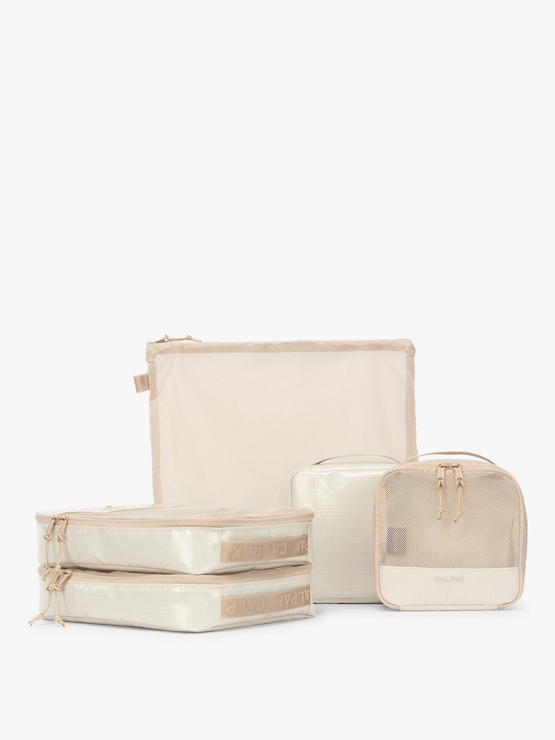 CALPAK Terra 5-Piece Packing Cube Set in off-white beige White Sands with two small cubes, two medium cubes, and one large mesh cube with zippers and mesh