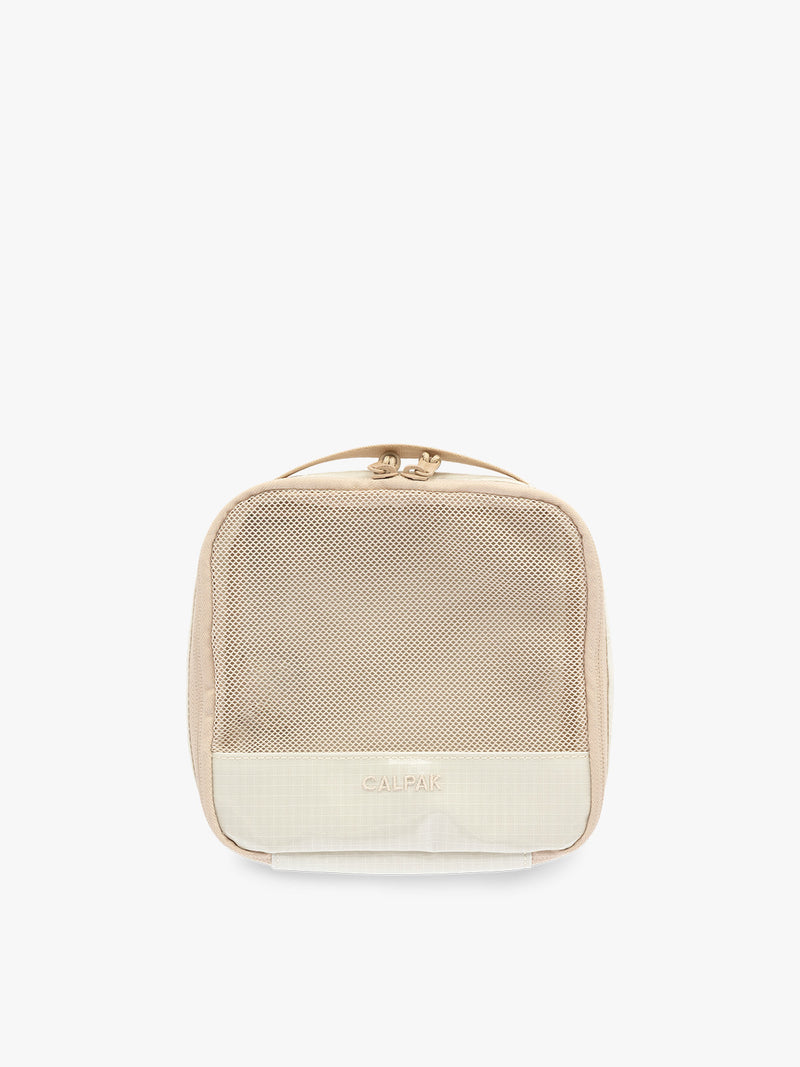 Small size packing cube of the CALPAK Terra 5-Piece Packing Cube Set in off-white beige White Sands with two small cubes, two medium cubes, and one large mesh cube with zippers and mesh