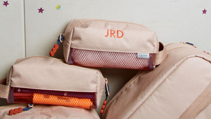 CALPAK Kids Collection tan Khaki Pencil Case with initials "JRD" embroidered through Personalization