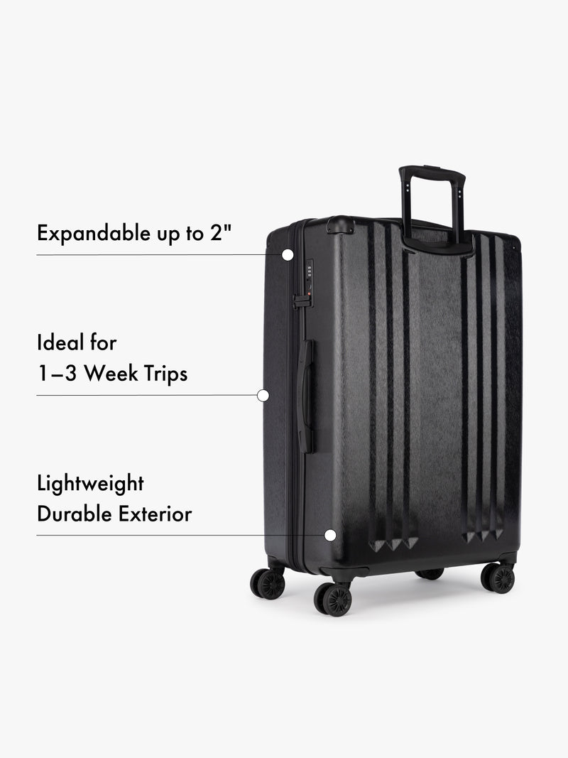 CALPAK large black suitcase with text highlighting features on a white background