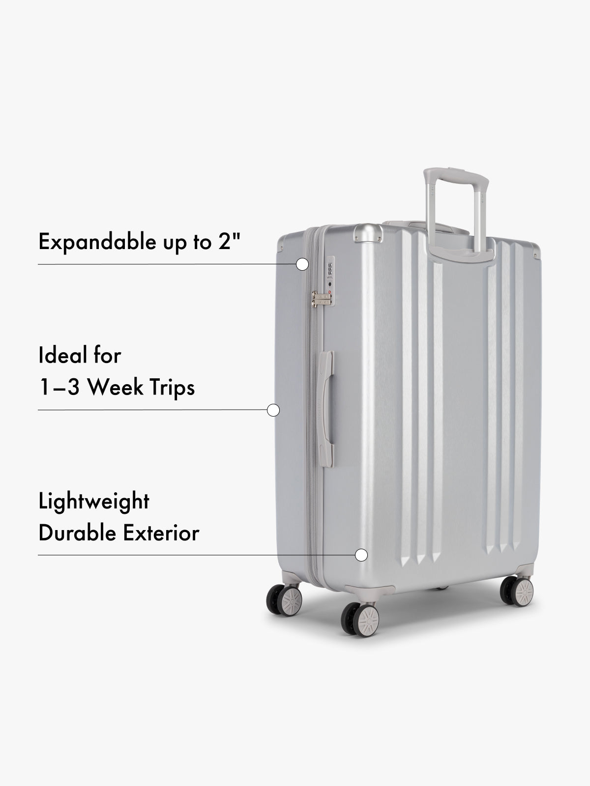 CALPAK large silver suitcase with text highlighting features on a white background; LAM3000-SILVER