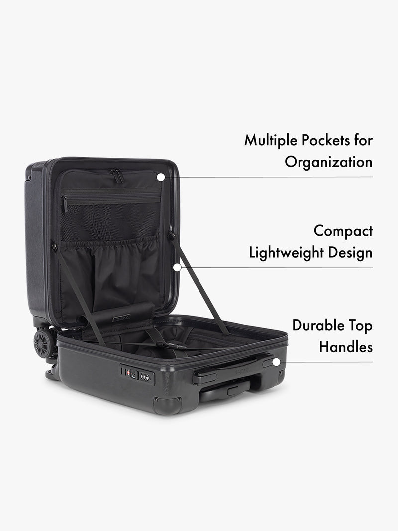CALPAK Ambeur Black carry on suitcase with open lid showing multiple pockets, compact design, and durable top handles on a white background