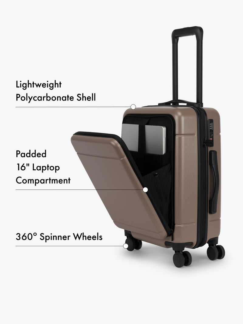 CALPAK Hue Front Pocket Carry On Luggage in Brown with open compartment showing laptop space, labeled features on a white background