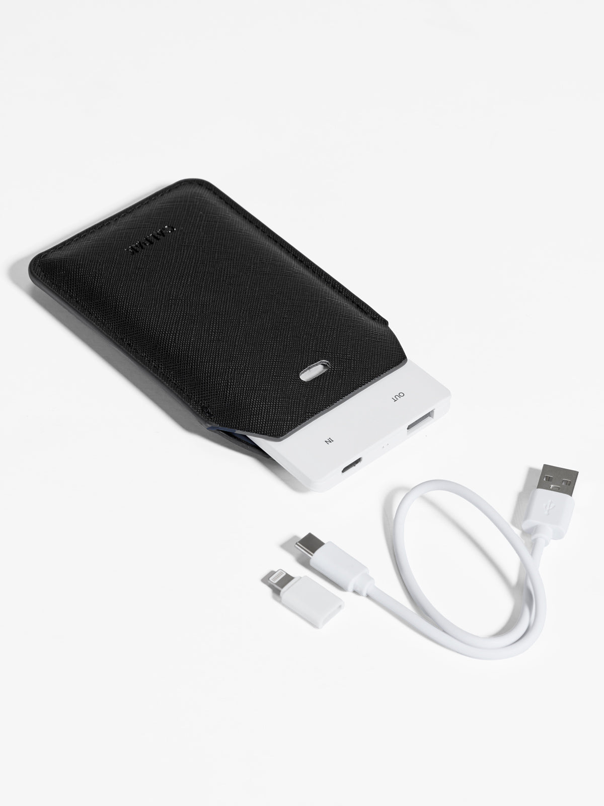 Black CALPAK Portable Luggage Tag + Charger featuring included cord, USB-C and Lighting adaptor compatibility and 2500 mAh battery power; APT2401-BLACK