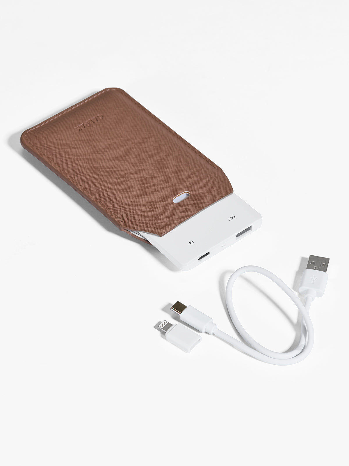 Caramel brown CALPAK Portable Luggage Tag + Charger featuring included cord, USB-C and Lighting adaptor compatibility and 2500 mAh battery power; APT2401-CARAMEL